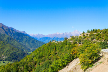 Colorful autumn landscape in the mountains of Georgia, against a bright blue sky. Upper Svaneti, Samegrelo, Mestia.