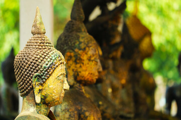 close up to ancient buddha head many style have rust and erosion on skin