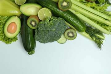 Fresh green vegetables on white background, space for text