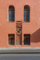 Wall of an old building with opens of brick Mansory.