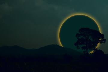 Fototapeta na wymiar Ring lunar eclipse back silhouette tree and mountain on the night sky