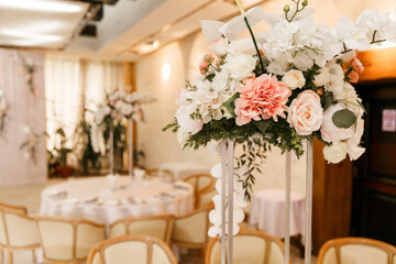 Festive Floral decor on wedding banquet tables in white colors with cutlery