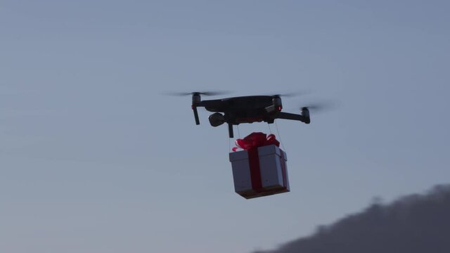 small drone flying cross country carrying giftbox to its destination
