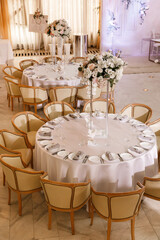Festive Floral decor on wedding banquet tables in white colors with cutlery
