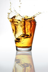 Ice cubes splashed into a whiskey glass
