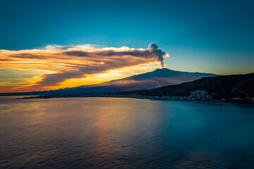 Epic eruption of Mt Etna during sunset. Volcanic eruption by the sea