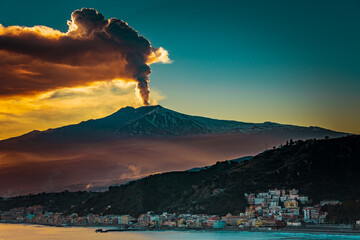 Massive eruption of Mt Etna during sunset. Volcanic eruption by the sea