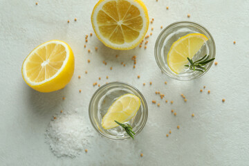 Shots of tequila on white textured table