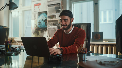 Young Specialist Sitting at His Desk Works on Computer in Modern Creative Office. Young...