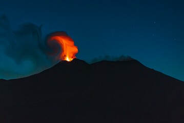 Fire and lava flowing on the top  of mount Etna during eruption. Night scenery 