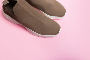 modern beige sneakers with white soles on pink background  - Image