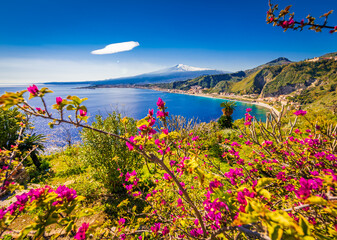 Buganvillee flowers, turquoise sea and mountain scenery from Taormina, Sicily 