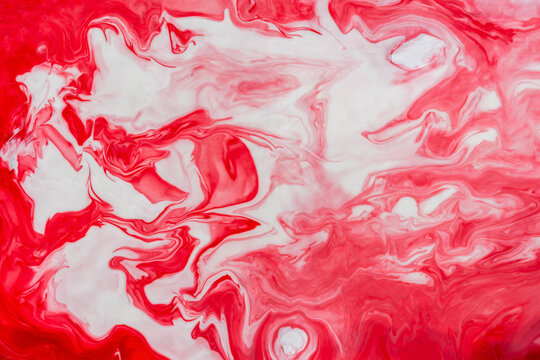 Red and white fluid art, abstract creative background with acrylic paints. Dynamic lines, free movement, outburst of emotions, passion, free natural form. The concept of strawberries with cream.