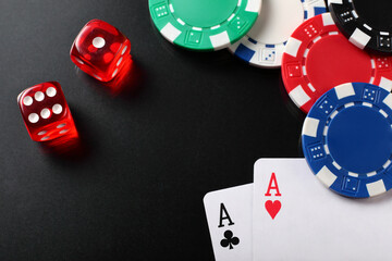 Casino chips, dice and playing cards on balck background. Backdrop with copy space.