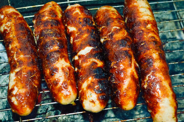 close-up - delicious grilled sausages with appetizing crust
