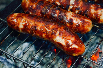 close-up - delicious grilled sausages with appetizing crust