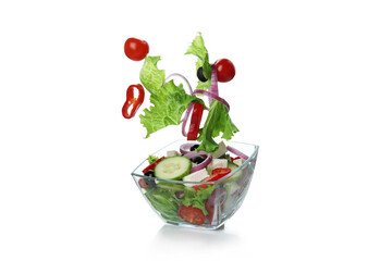 Bowl of greek salad and ingredients isolated on white background