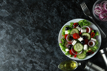 Concept of delicious food with Greek salad on black smokey background