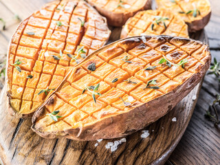Baked batata on the old wooden table.
