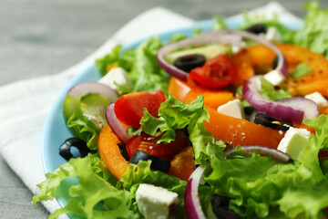 Plate of Greek salad and kitchen towel, close up