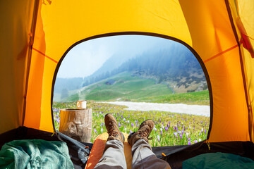 Spectacular view of nature from open tent entrance. The beauty of romantic trekking and camping.