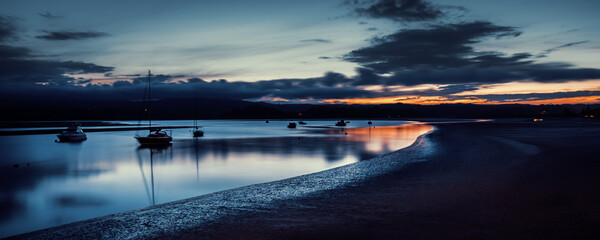 Sunset reflection during the blue hour on a beach near Whakatane, New Zealand