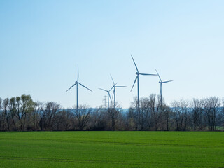 Windmills against blue sky in sunshine