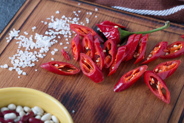 chili peppers, sliced on a kitchen board