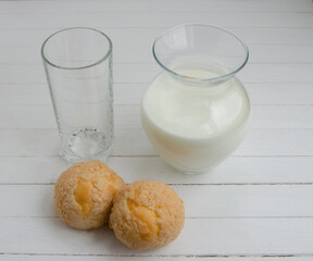 White cow's milk in a clear glass on a light background