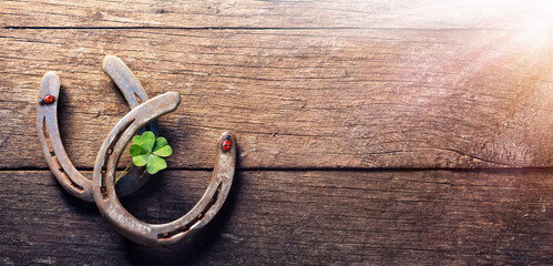 Horse Shoes With Ladybugs And Four Leaf Clover On Wooden - Lucky Charm Symbols
