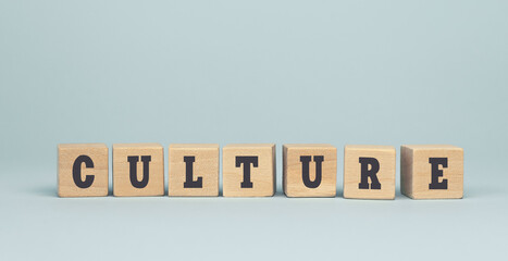 The word culture made from wooden cubes on blue background