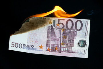 Five hundred Euros are burning with fire isolated on black