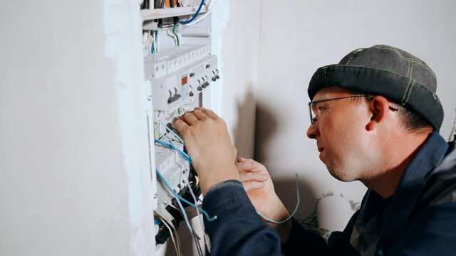 The Master Electrician connects the wires to the circuit breakers in the electrical panel.