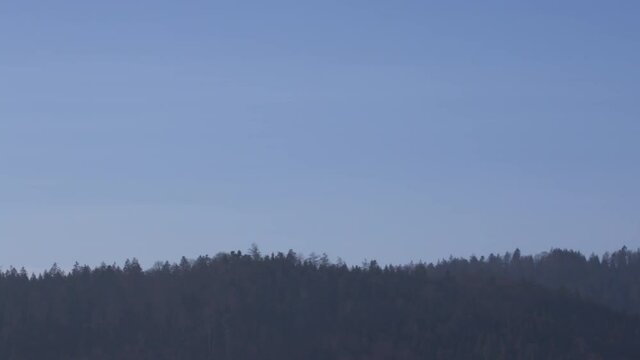 delivery drone carrying parcel flying across the blue sky