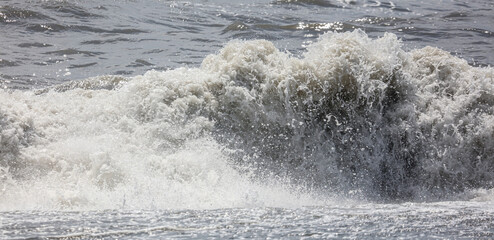 Splashing big waves on the seashore.