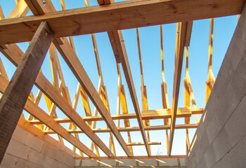 Wooden boards on the roof of the house against the sky.