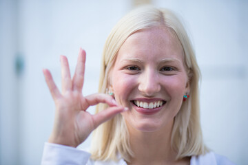 Blond woman on the street. Woman gesturing.