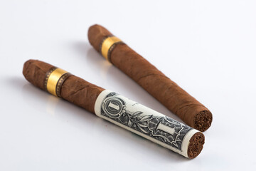 Rolled Cash and Cuban cigar stock photoSmoking cost concept. Cigarettes in euros and Dollers  background. 3d illustration stock photo