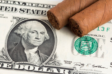 Cuban cigar on a dollar bills on the table stock photo