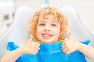 Pretty happy little boy in dental office, having his teeth checked.