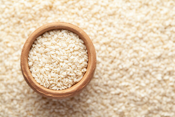 Macro Close-up of Organic White  Sesame seeds(Sesamum indicum) polished or white Til without shell in an earthen clay pot (kulhar) on the self background. Top view