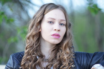 Obraz premium Portrait of a young beautiful girl in the park