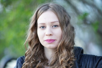 Portrait of a young beautiful girl in the park