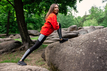 Young girl doing stretching in the park