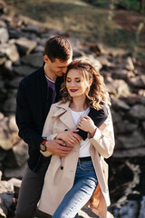 Woman blonde cuddles with boyfriend in the street