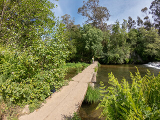 Old stone footbridge over the Neiva River in Antas, Esposende, Portugal.