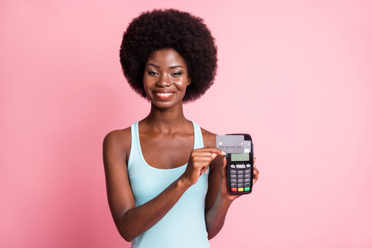 Photo of beautiful brunette trendy afro american lady hold credit swipe card reader isolated on pink color background