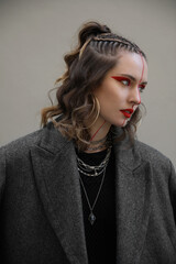 Vertical portrait of young woman with braids hair style looking aside.