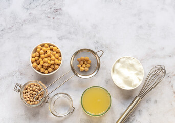 Canned chickpea aquafaba. Egg replacement and substitutes. Vegan cooking concept. whipped foam in a bowl. Top view, copy space.