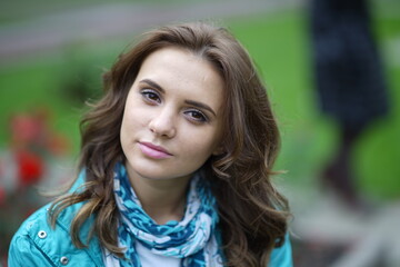 Fototapeta premium Portrait of a young beautiful girl in the park